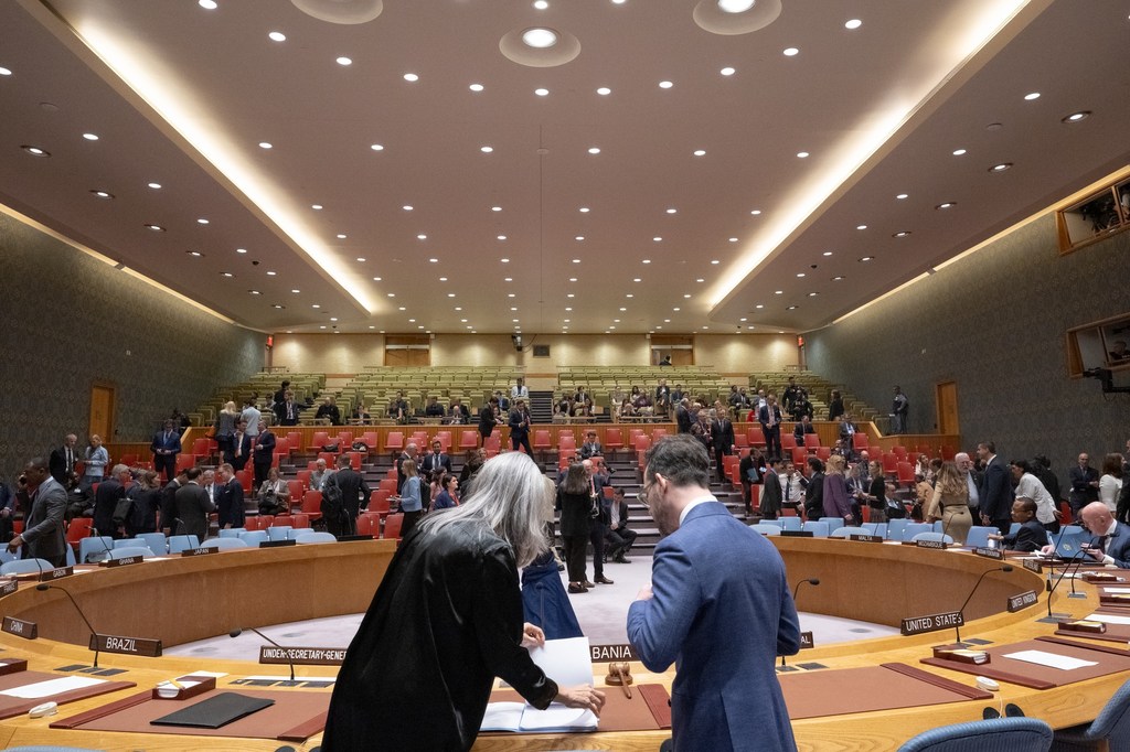 In this file photo, two UN staff members discuss some matters, as the Security Council prepares to convene a meeting.